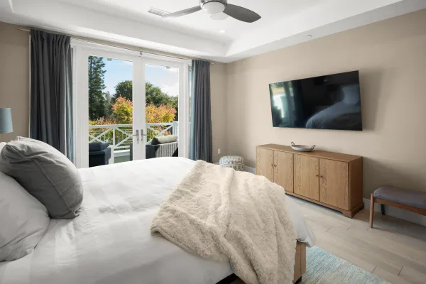 a bedroom with a bed and a flat screen tv