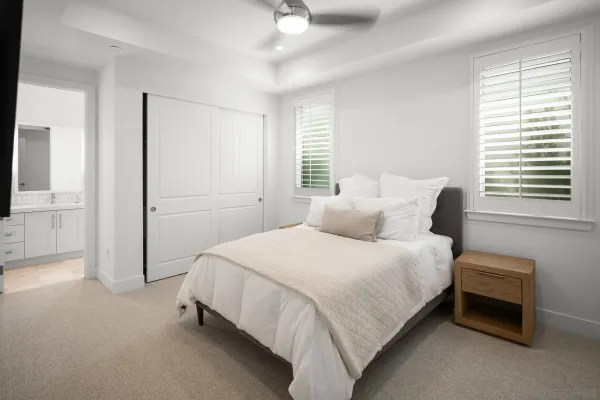 a bedroom with a bed and a flat tv screen