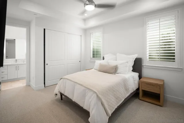 a bedroom with a bed and a flat tv screen