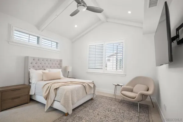 a bedroom with a bed and a chair