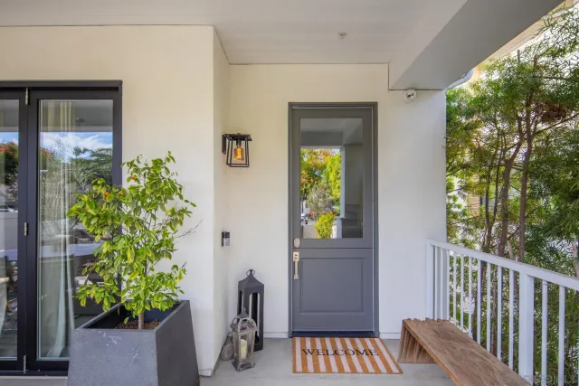 a view of a room that has a window and wooden floor