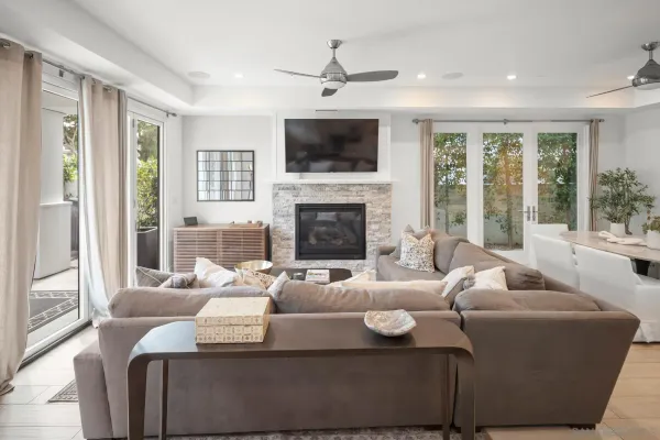 a living room with furniture a large window and a fireplace