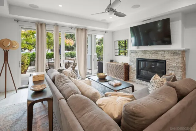 a living room with furniture a fireplace and a flat screen tv