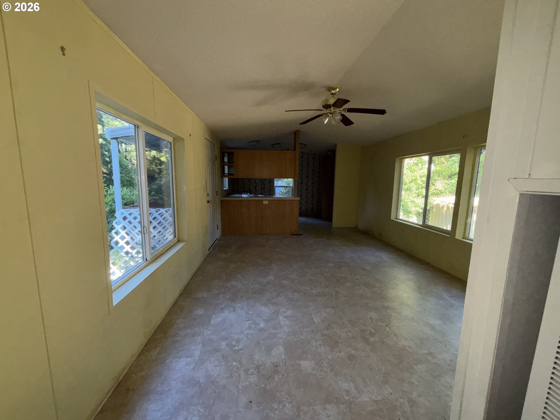 64 Outer Drive Florence, OR 97439 - Photo 7 of 8 an empty room with windows and fan
