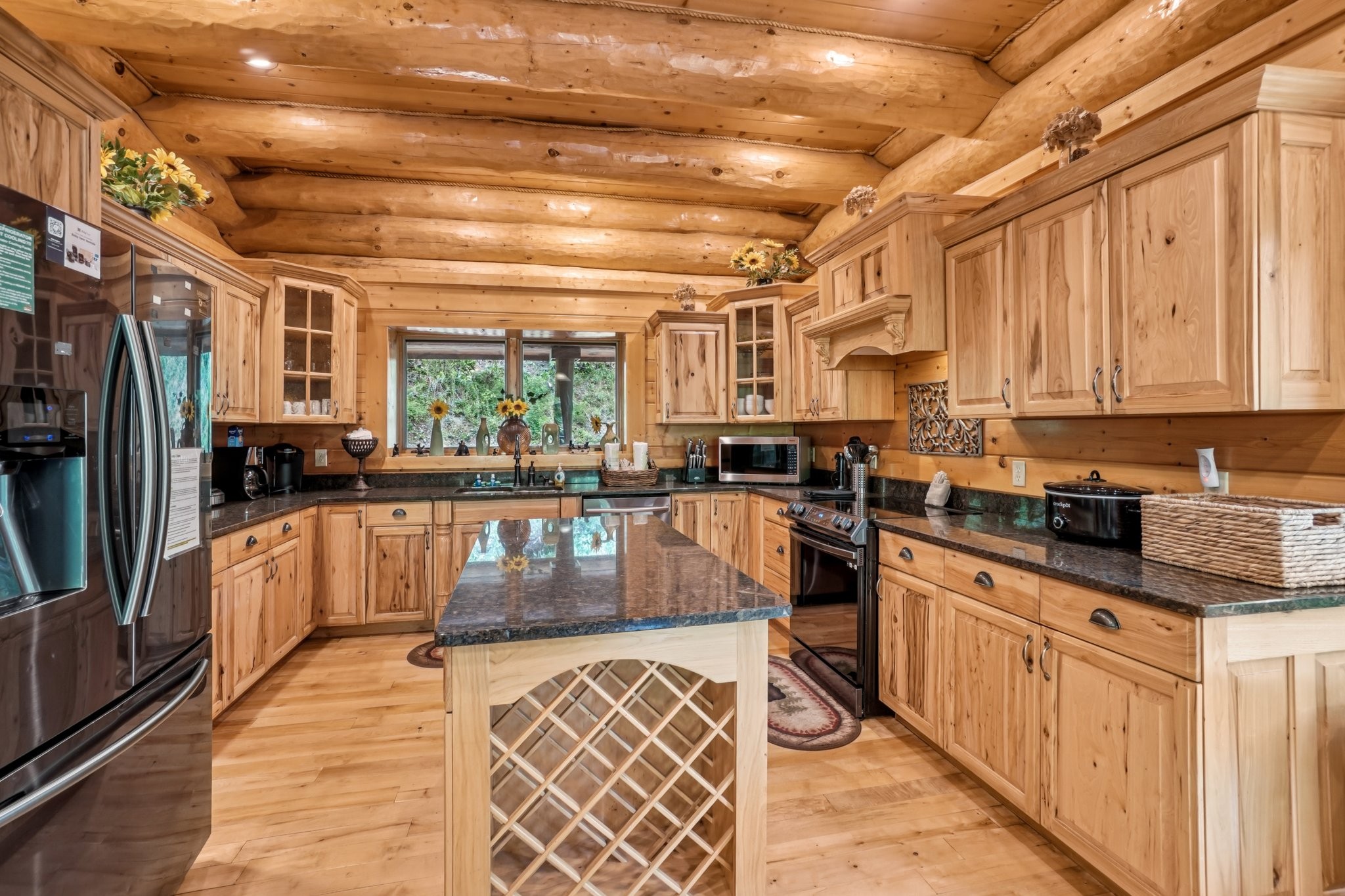 641 Pinnacle Vista Road Gatlinburg, TN 37738 - Photo 15 of 68 a large kitchen with stainless steel appliances granite countertop a stove a sink dishwasher and cabinets with wooden floor