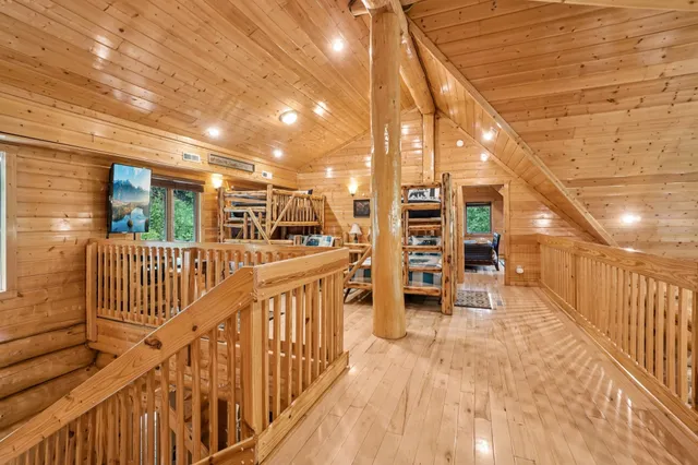a living room with furniture a pool table and a fireplace