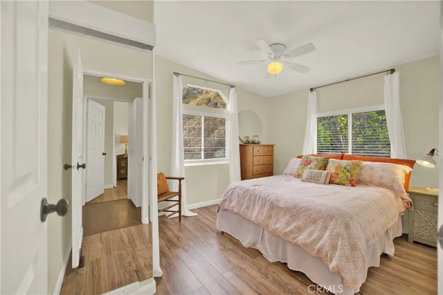 a bedroom with a bed and a dresser next to a window
