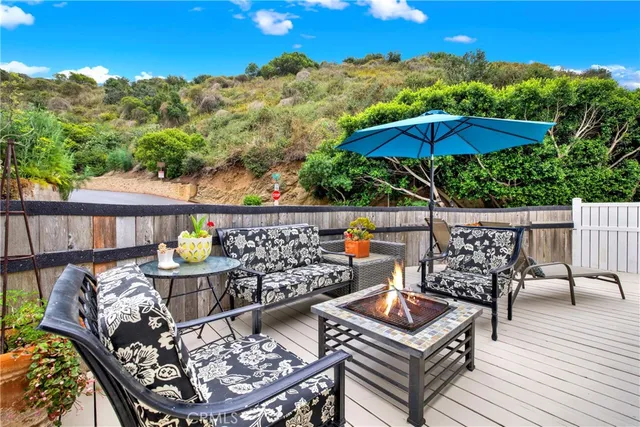 a view of a balcony with chairs and wooden floor