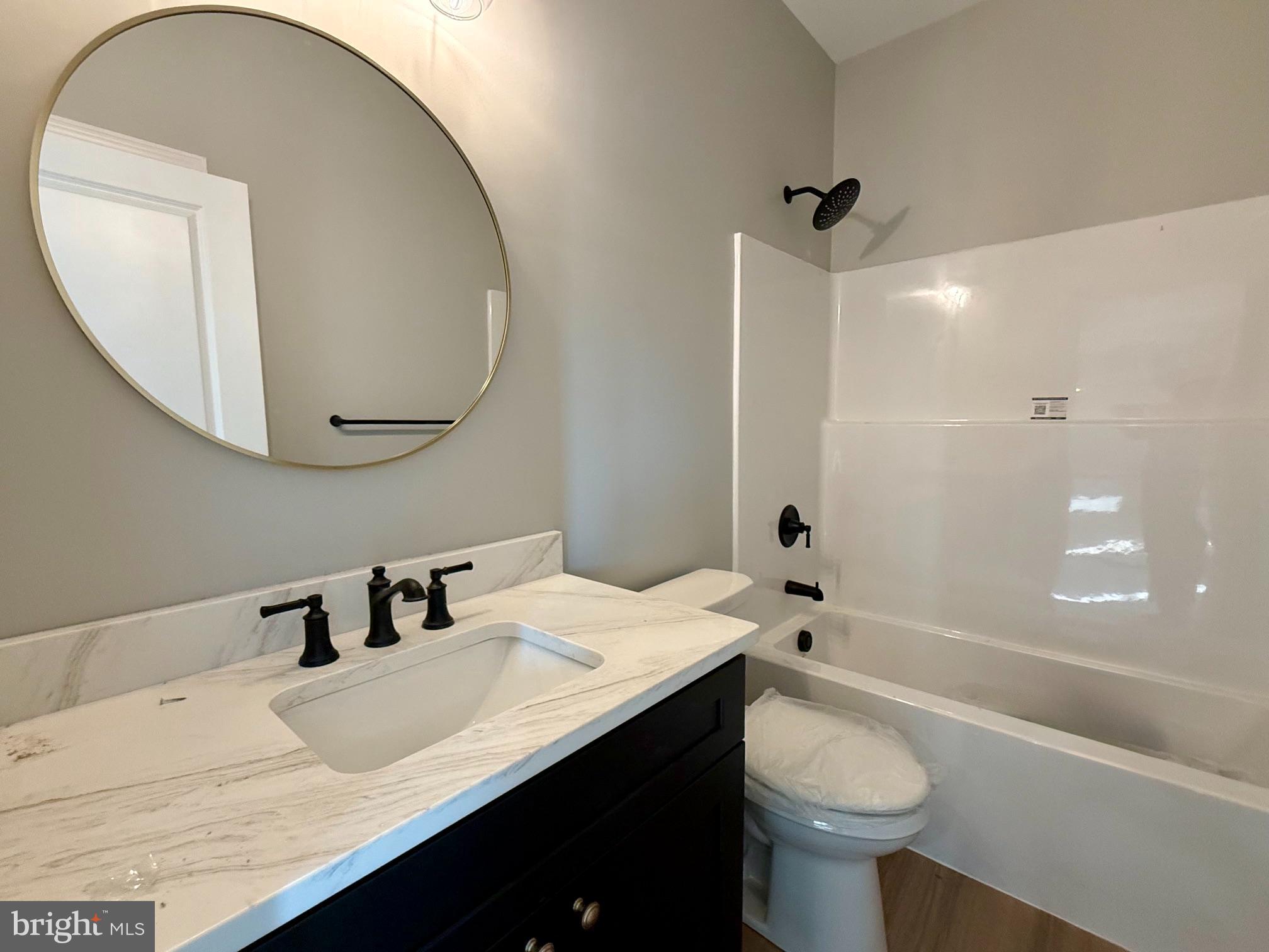 17480 Lighthouse Commons Drive Piney Point, MD 20674 - Photo 16 of 23 a bathroom with a sink a toilet and a mirror
