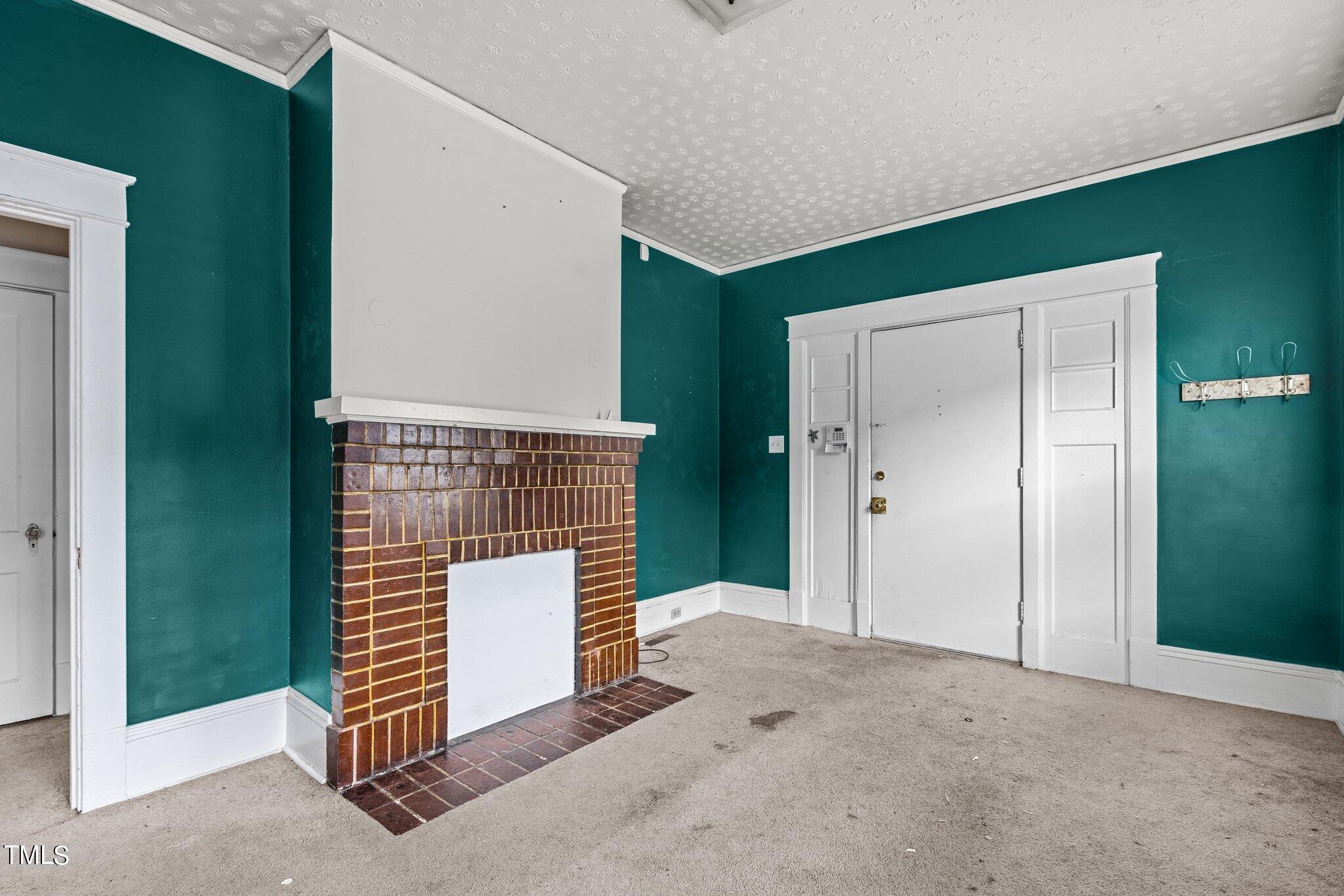 810 East Edenton Street Raleigh, NC 27601 - Photo 5 of 32 a view of an empty room with wooden floor and entryway