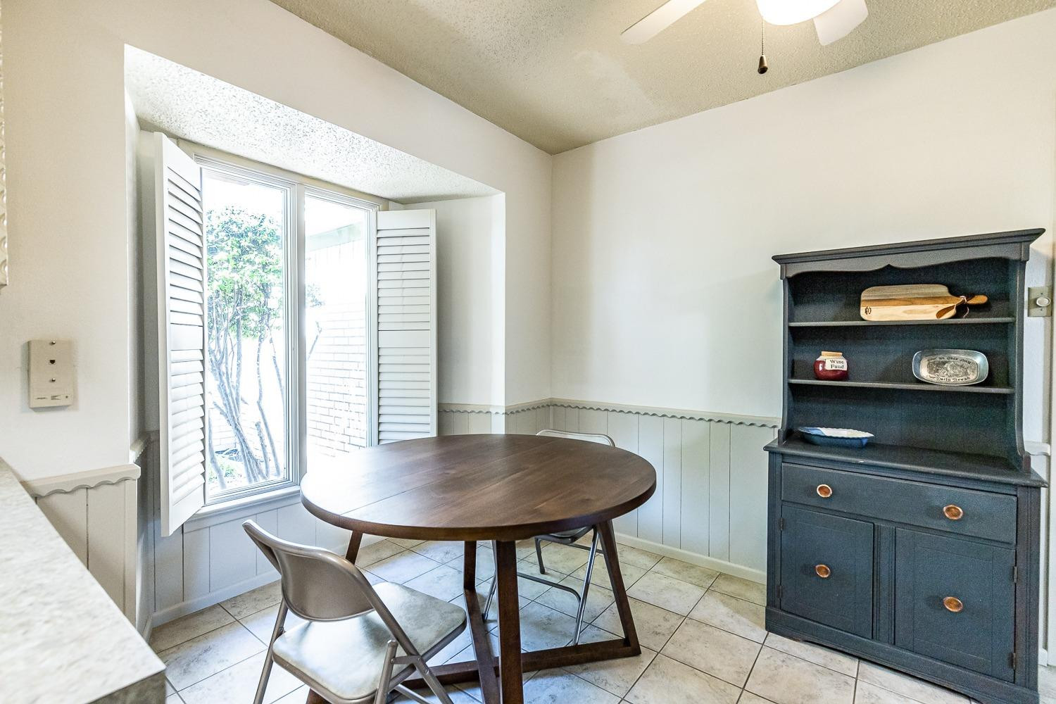 4602 63rd Street Lubbock, TX 79414 - Photo 11 of 37 a view of a dining room with furniture and window