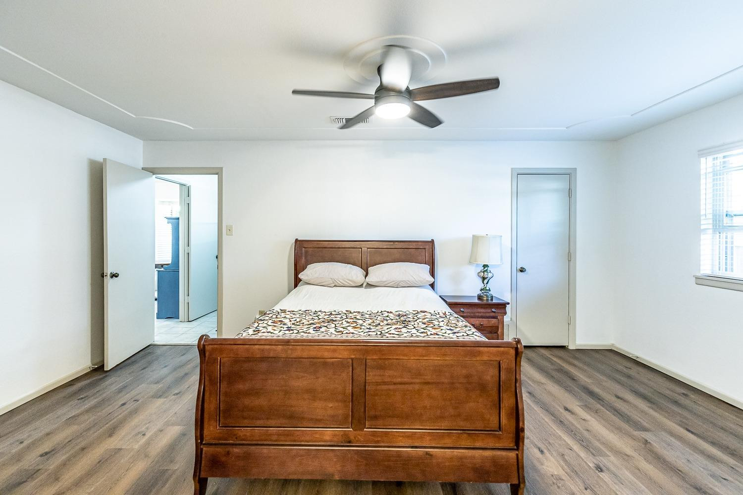4602 63rd Street Lubbock, TX 79414 - Photo 16 of 37 a bedroom with a bed and wooden floor