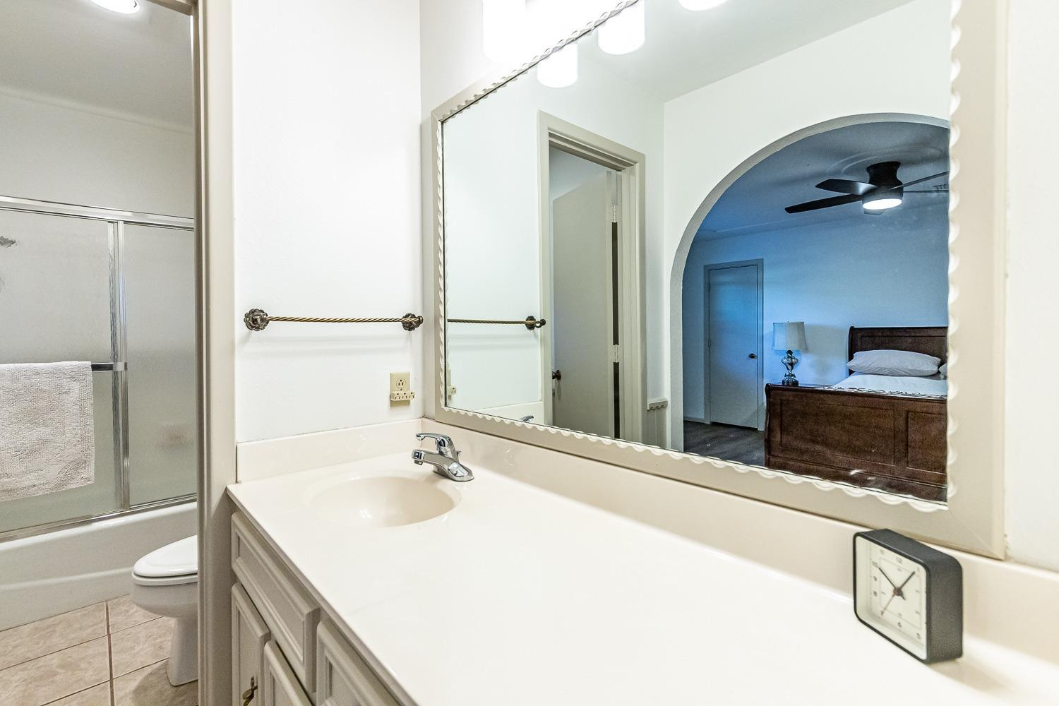 4602 63rd Street Lubbock, TX 79414 - Photo 18 of 37 a bathroom with a sink and a mirror