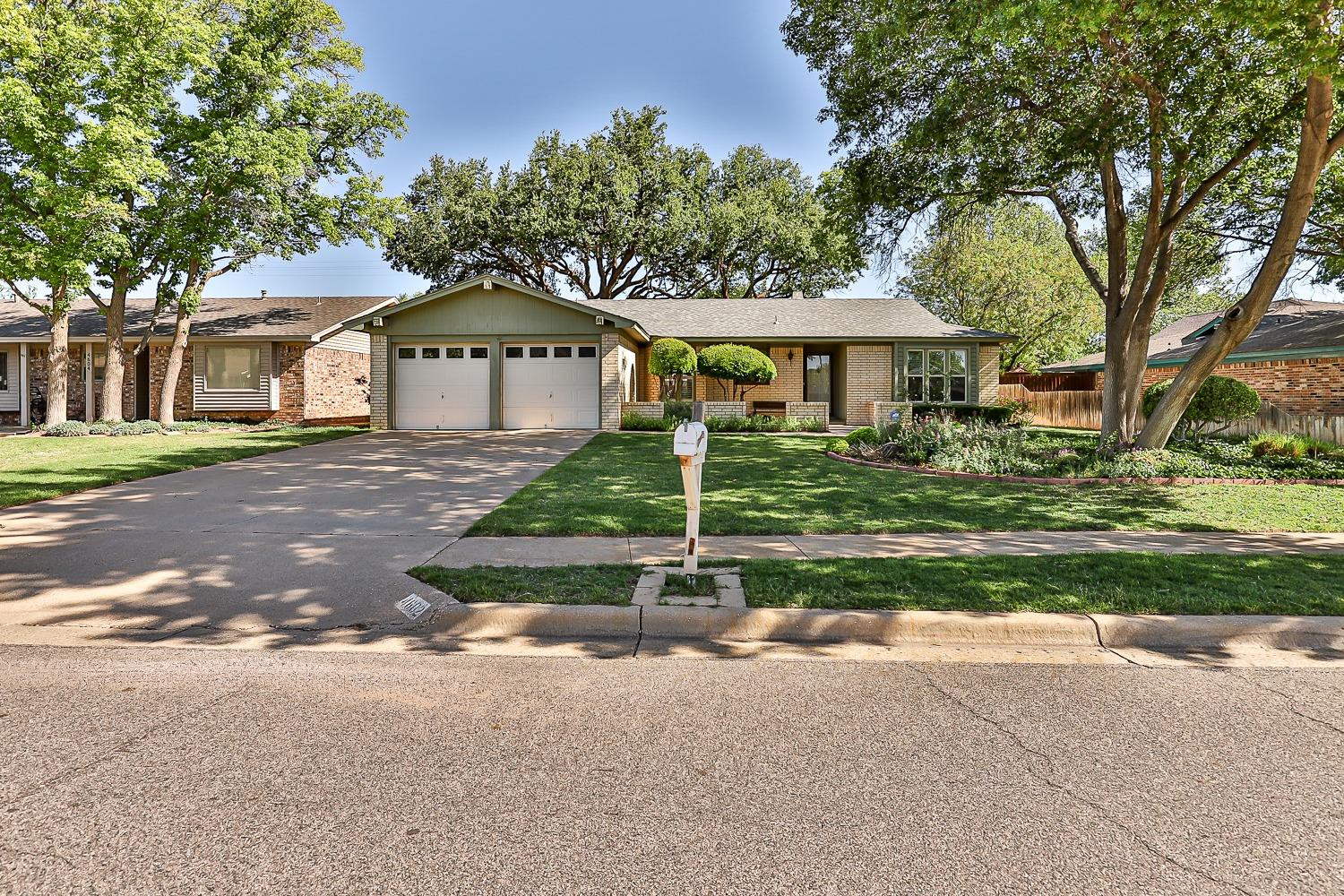 4602 63rd Street Lubbock, TX 79414 - Photo 2 of 37 a front view of a house with a yard
