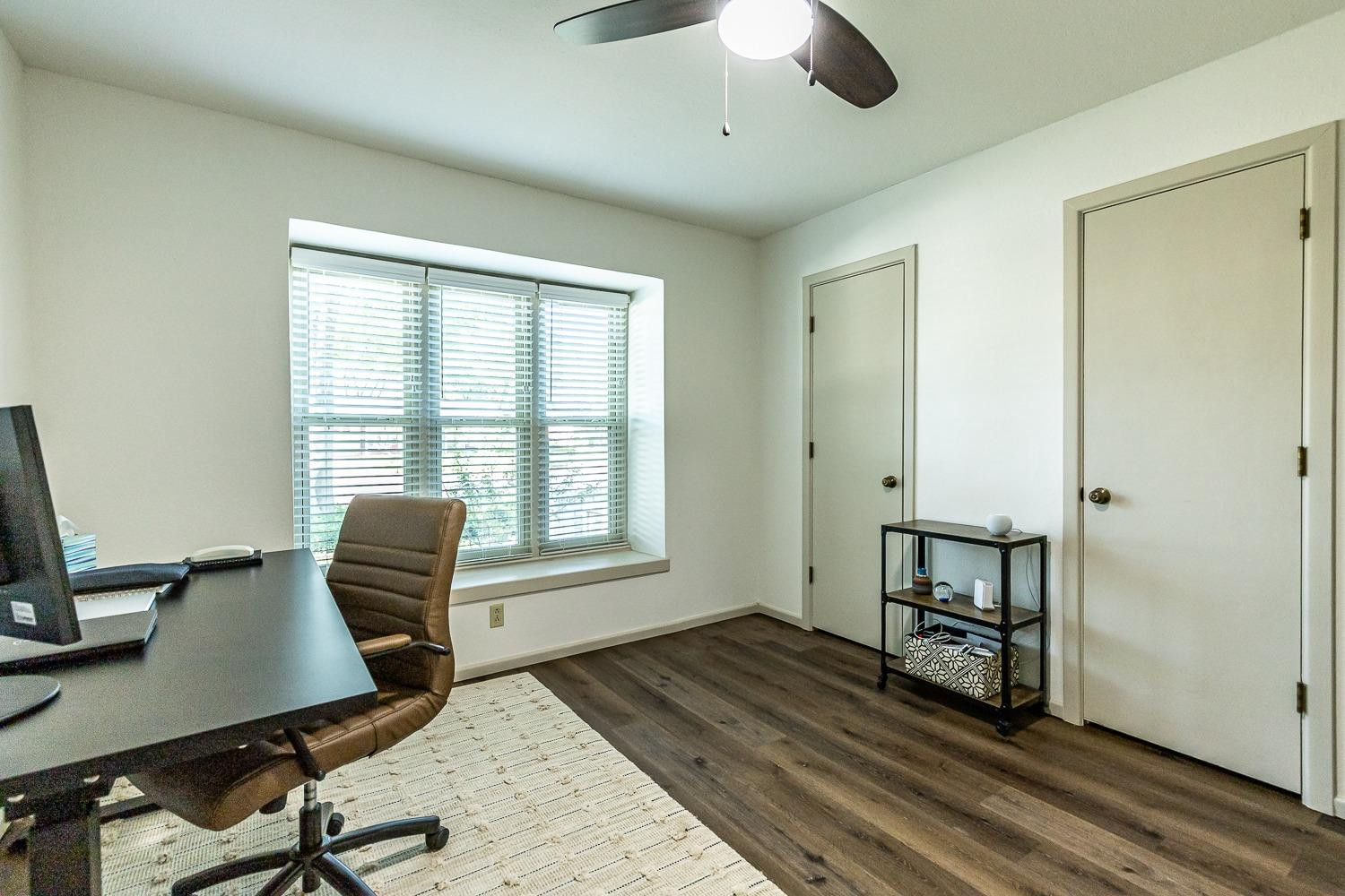4602 63rd Street Lubbock, TX 79414 - Photo 21 of 37 a view of a workspace with furniture and a window
