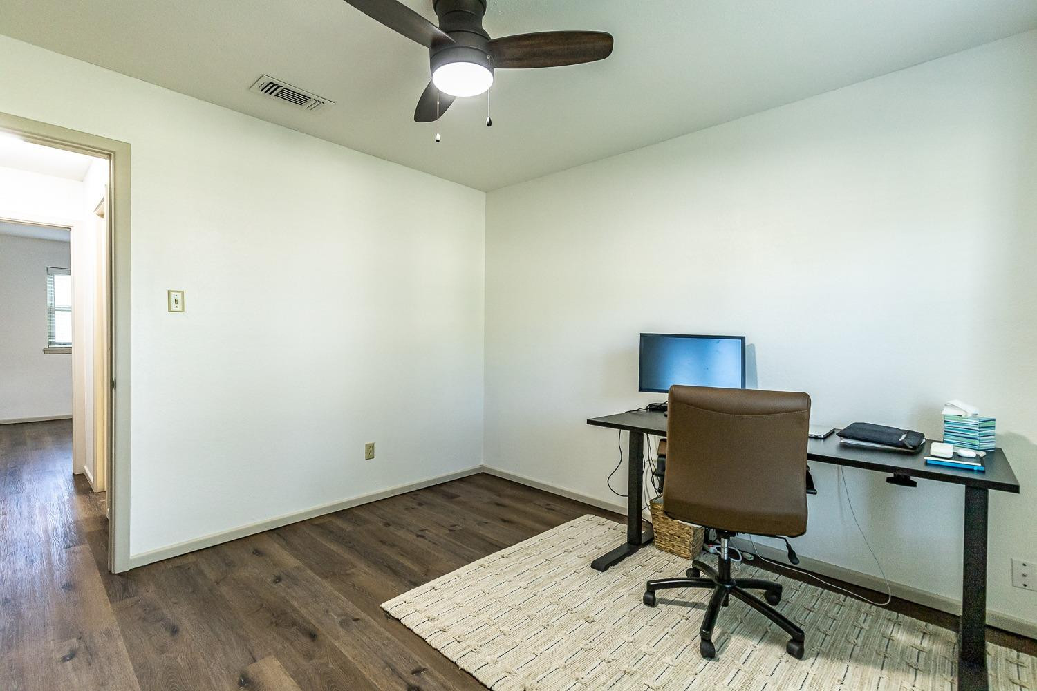 4602 63rd Street Lubbock, TX 79414 - Photo 22 of 37 a workspace with furniture and wooden floor