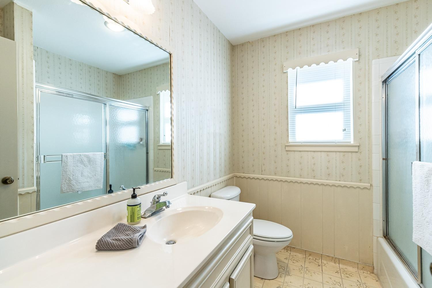 4602 63rd Street Lubbock, TX 79414 - Photo 23 of 37 a bathroom with a sink a toilet and shower