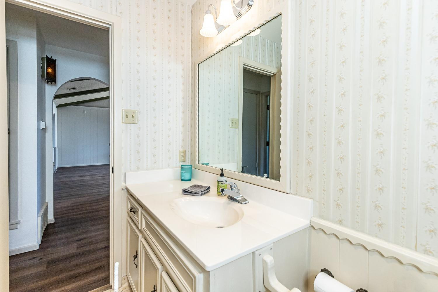 4602 63rd Street Lubbock, TX 79414 - Photo 24 of 37 a bathroom with a sink and a mirror