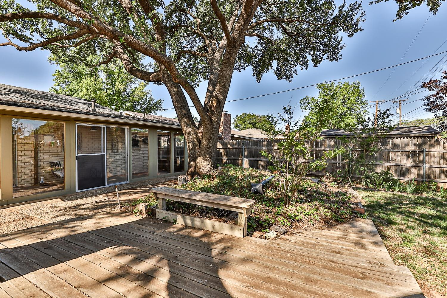 4602 63rd Street Lubbock, TX 79414 - Photo 32 of 37 a backyard of a house with yard and outdoor seating