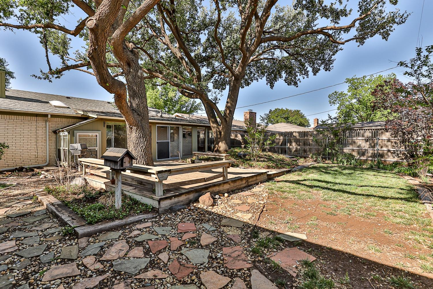 4602 63rd Street Lubbock, TX 79414 - Photo 37 of 37 a backyard of a house with barbeque oven and outdoor seating