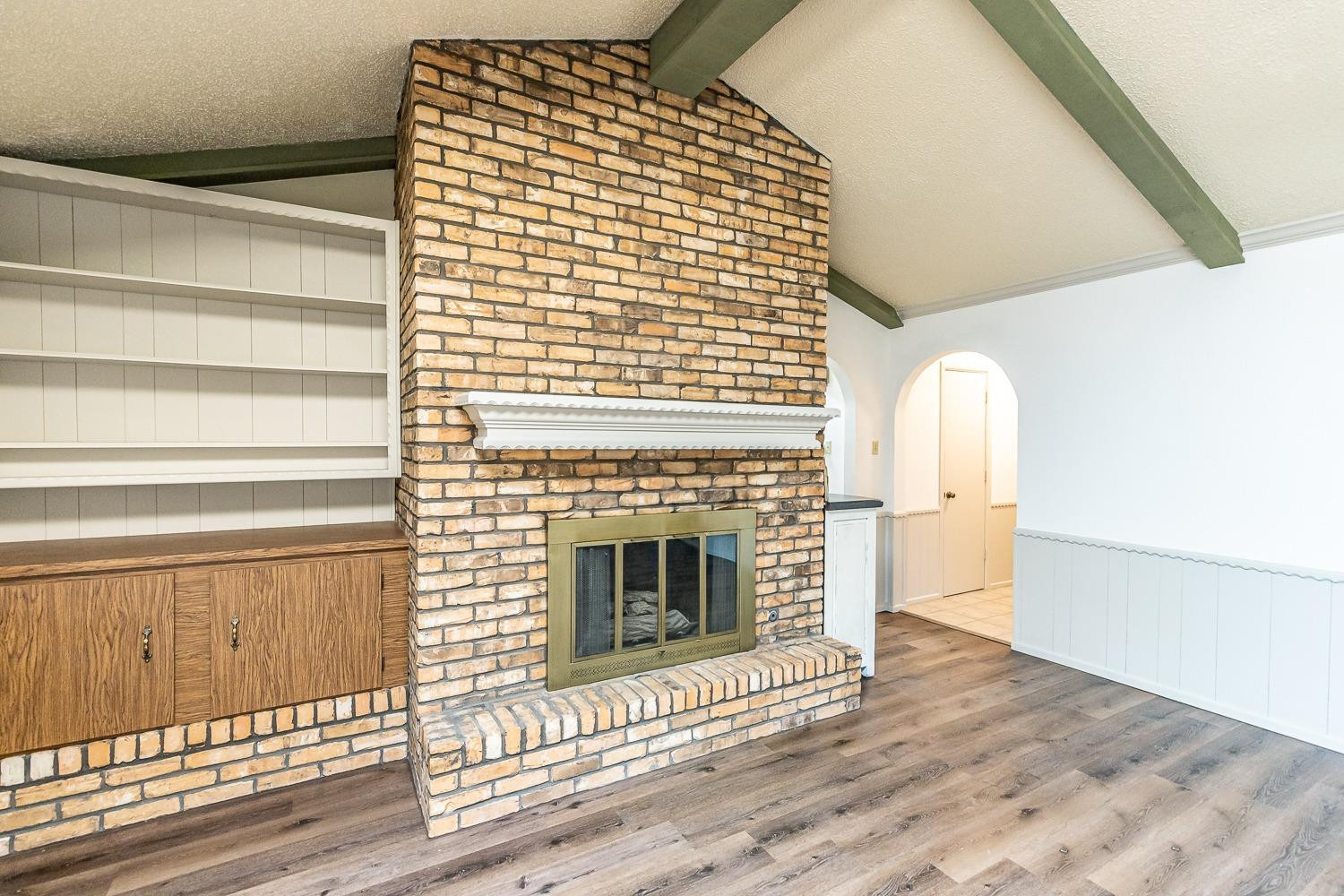 4602 63rd Street Lubbock, TX 79414 - Photo 8 of 37 a view of livingroom with fireplace and wooden floor