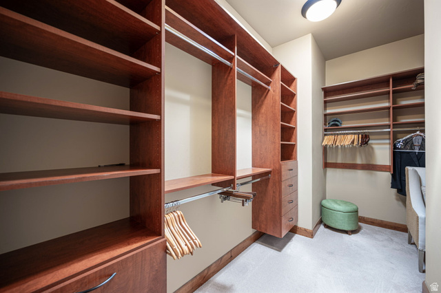 2331 West Entrada Trail, Unit 61 St. George, UT 84770 - Photo 31 of 69 Custom closet system featuring wood-finish shelving, multiple hanging rods, and built-in drawers