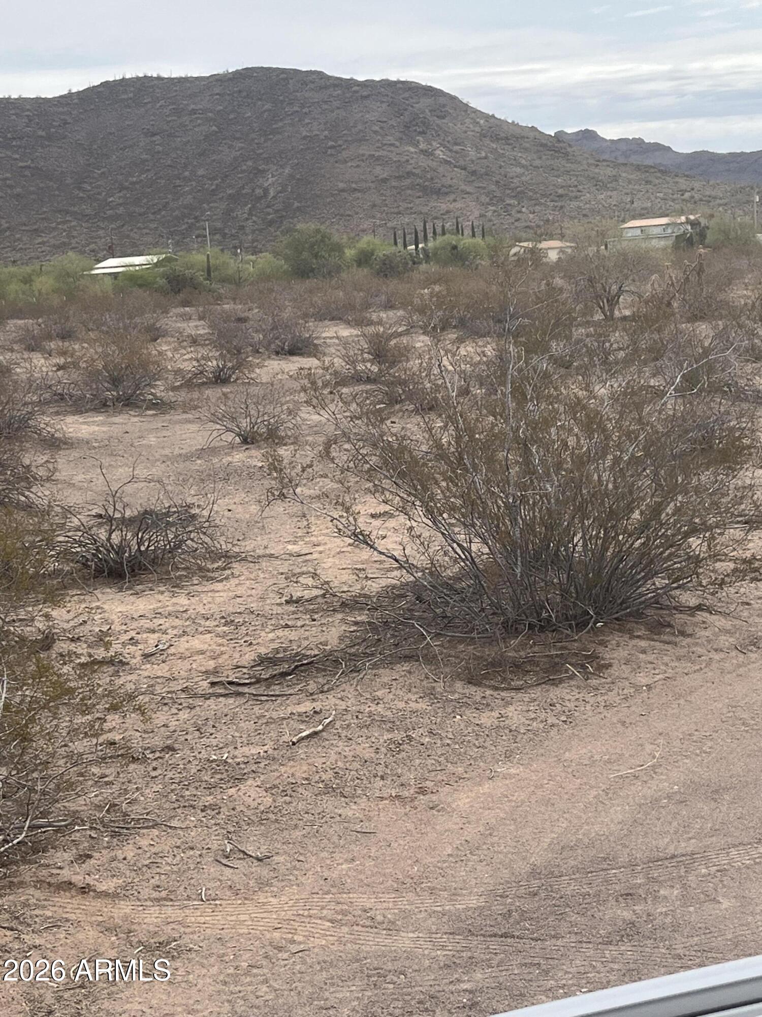 - St - Az 85321 Ajo, AZ 85321 - Photo 3 of 7 a view of a dry yard with mountains in the background