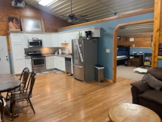 2048 North 3650th Road Serena, IL 60549 - Photo 68 of 82 a kitchen with stainless steel appliances wooden floor and a refrigerator