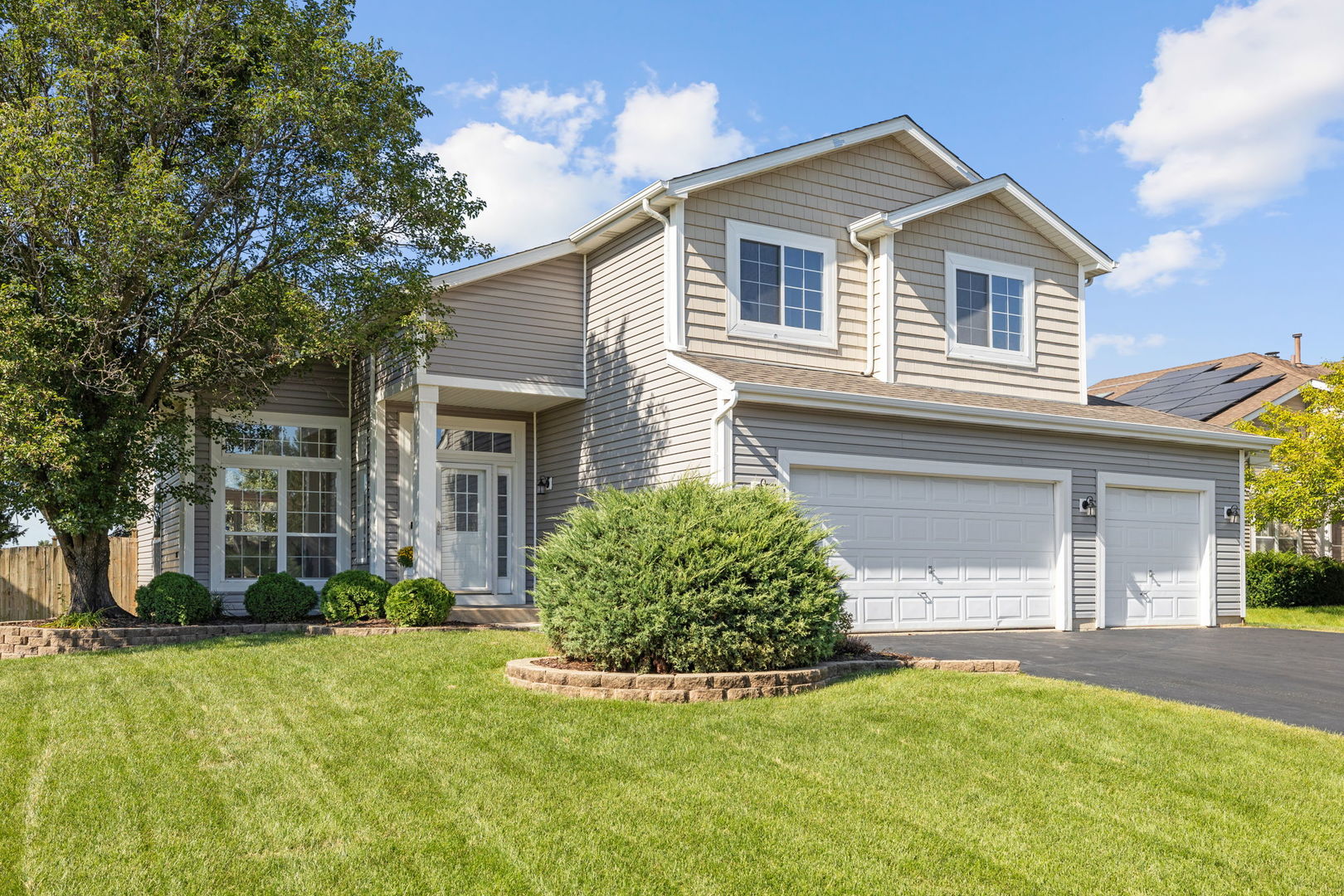 a front view of a house with a yard and garage
