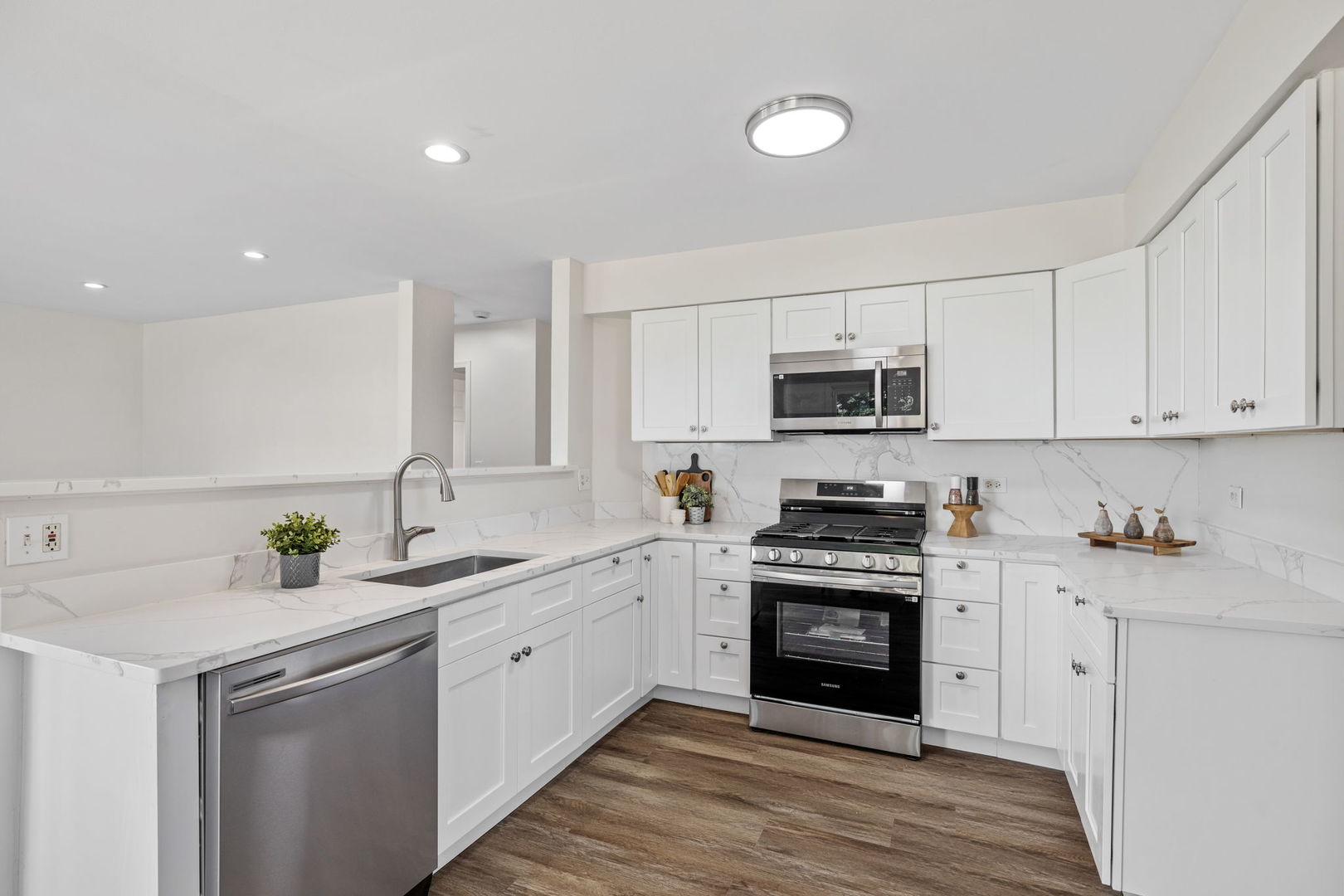147 Willow Bend Bolingbrook, IL 60490 - Photo 5 of 22 a kitchen with sink a microwave and cabinets