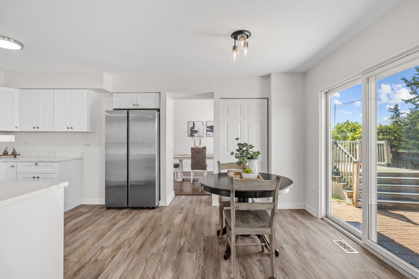147 Willow Bend Bolingbrook, IL 60490 - Photo 8 of 22 a kitchen with stainless steel appliances a dining table chairs and chandelier