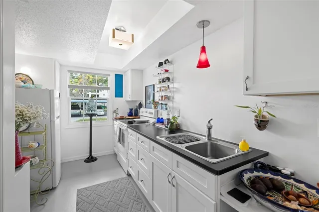 a kitchen that has a sink and a stove