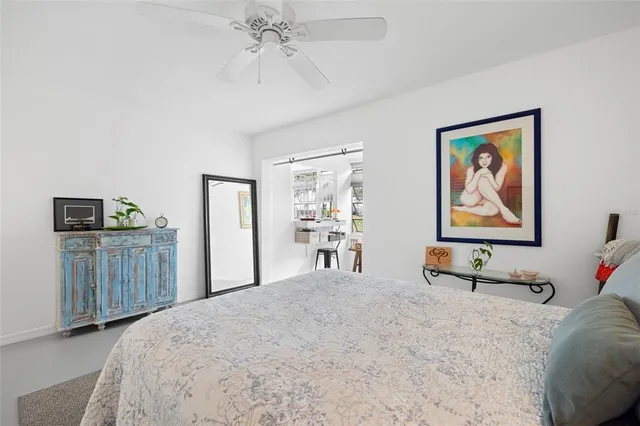 a room with a large window and furniture