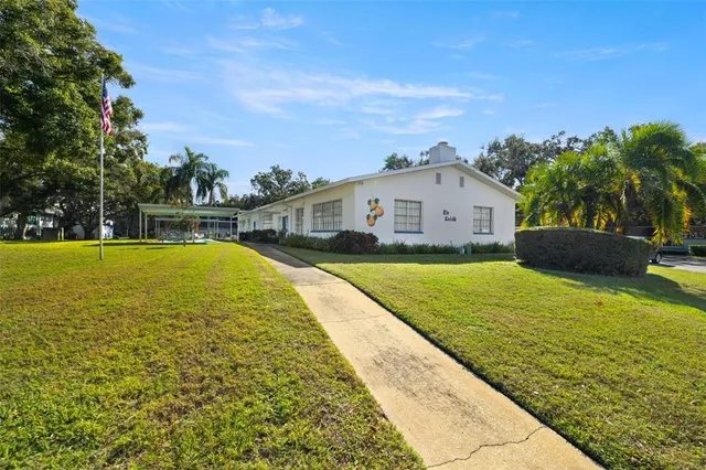 an aerial view of a house with a yard