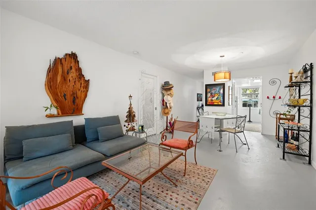 a living room with furniture and a book shelf