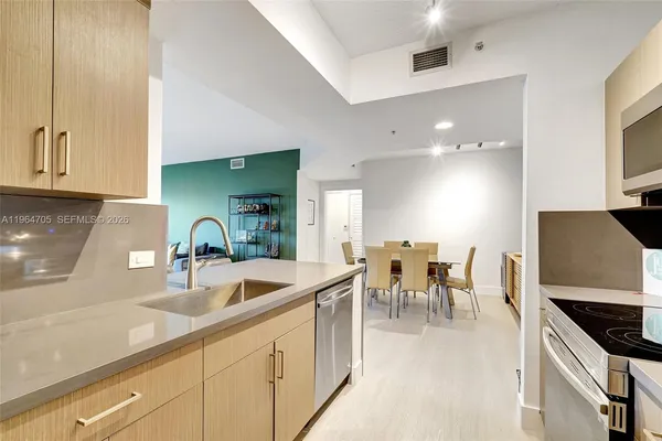a kitchen with sink and cabinets