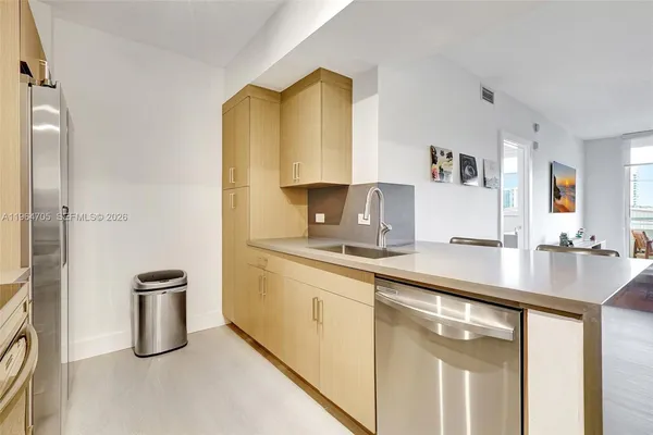 a kitchen with sink a stove and refrigerator