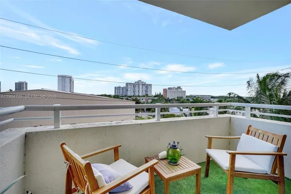 a roof deck with table and chairs