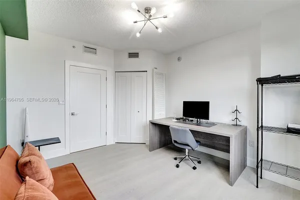 a view of a livingroom with workspace and a couch