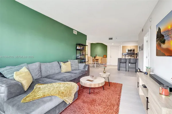 a living room with furniture and a flat screen tv