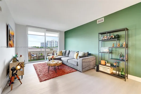 a living room with furniture and a floor to ceiling window