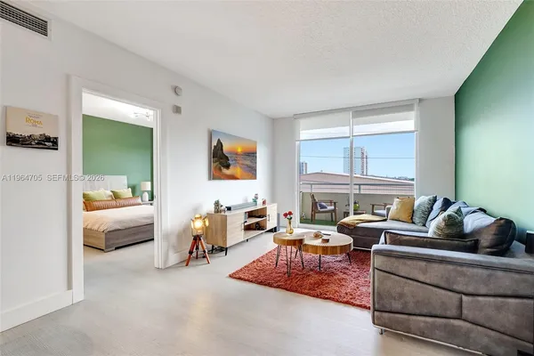 a living room with furniture and a large window