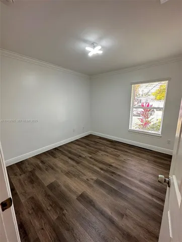 a view of an empty room and wooden floor