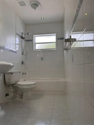 a bathroom with a toilet sink and shower