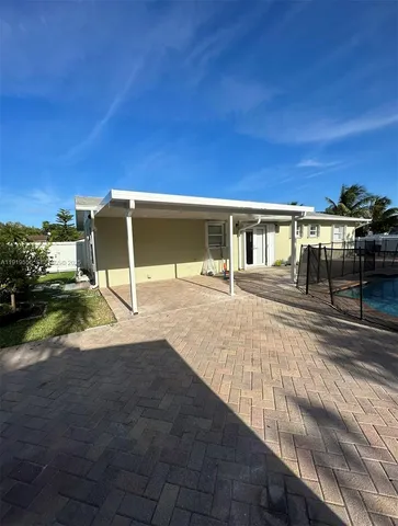 an aerial view of a house with a swimming pool