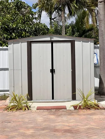 a view of a house with a wooden fence