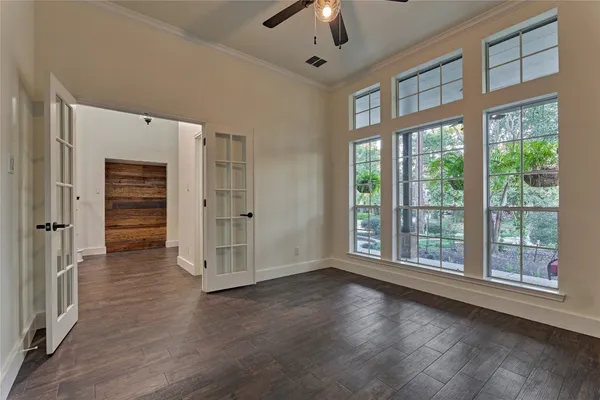 wooden floor fireplace and windows in an empty room