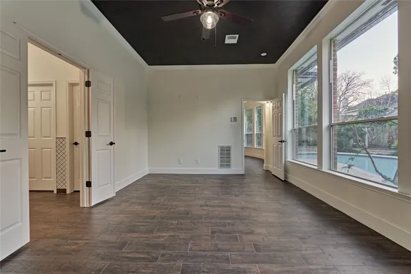 wooden floor in an empty room with a window