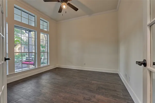a view of an empty room with a fireplace and a window