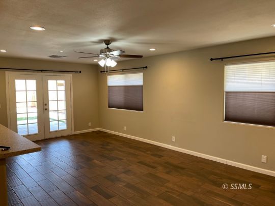 1104 South Yorktown Street Ridgecrest, CA 93555 - Photo 12 of 15 a view of an empty room with a window and wooden floor